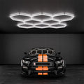 Panou LED honeycomb cu 8 hexagoane, 280W, lumină rece, montat într-un showroom modern, led-box.ro

